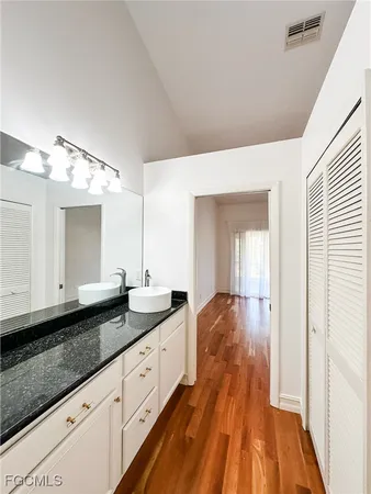 a spacious bathroom with a double vanity sink and a mirror