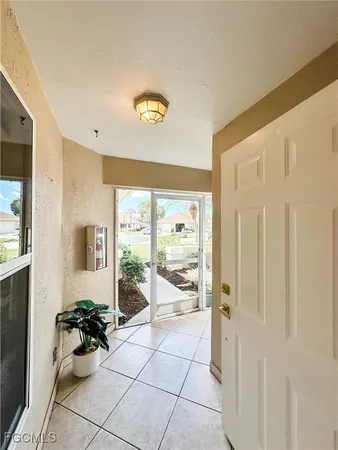 a hallway with a dining table and chairs