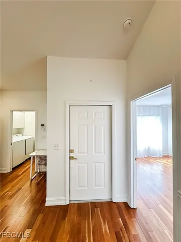 a kitchen with granite countertop a sink cabinets and wooden floor