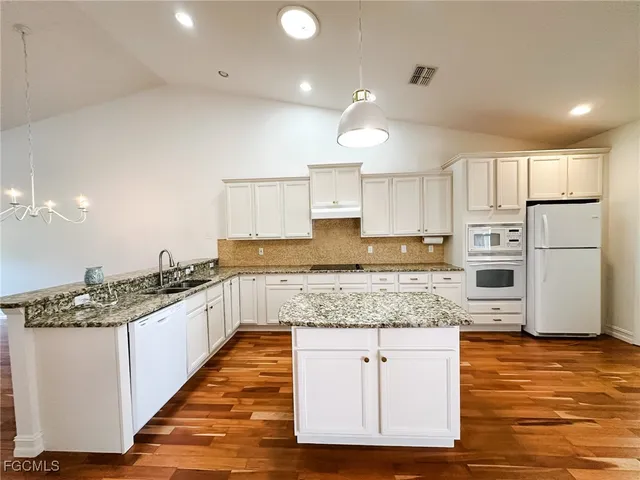 a view of a room that has a window and wooden floor