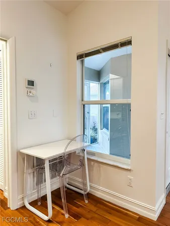 a view of a room that has a window and wooden floor
