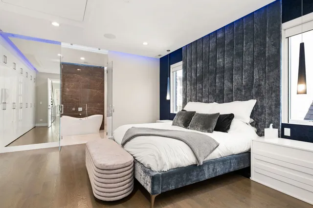 a bedroom with bed and wooden floor