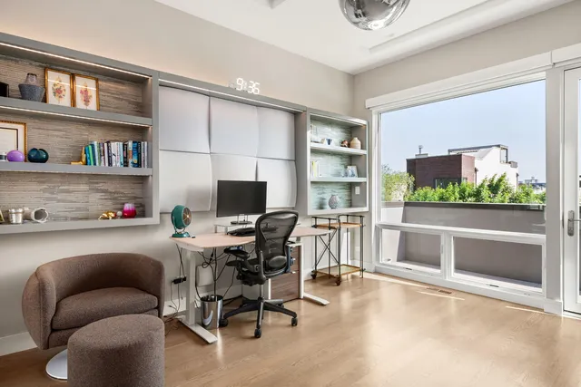 a work room with furniture and a flat screen tv