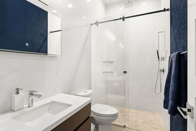 a bathroom with a sink toilet and shower