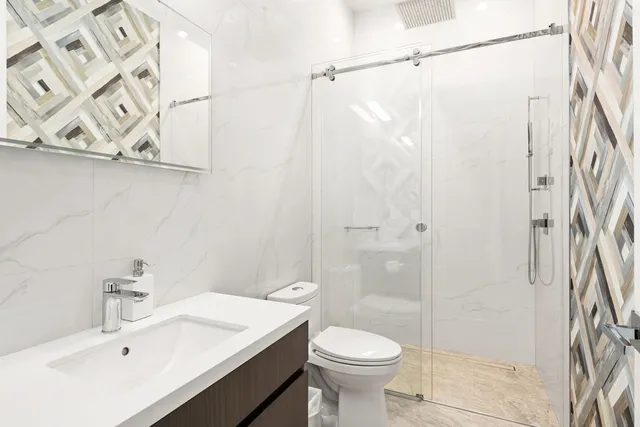 a bathroom with a sink toilet and shower