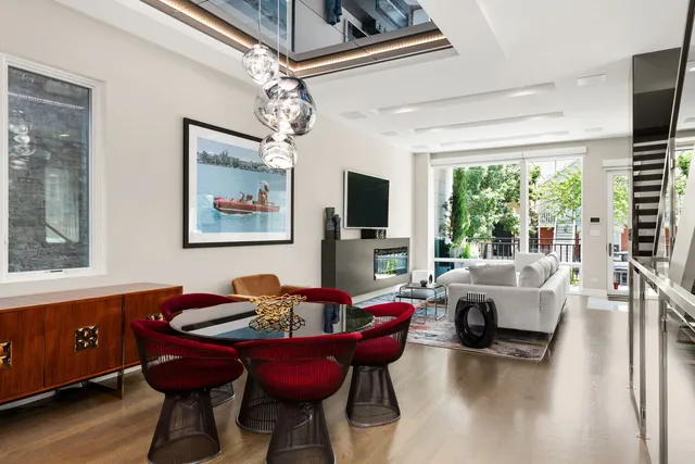 a living room with furniture a flat screen tv and a large window