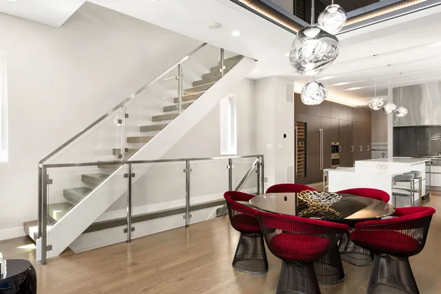 a view of a dining room with furniture and a chandelier