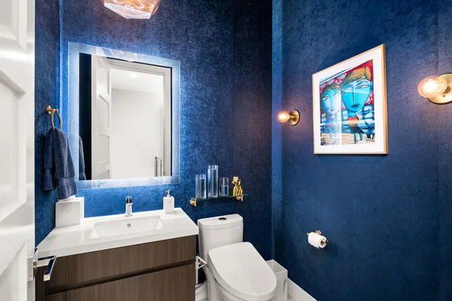 a bathroom with a toilet a sink and mirror