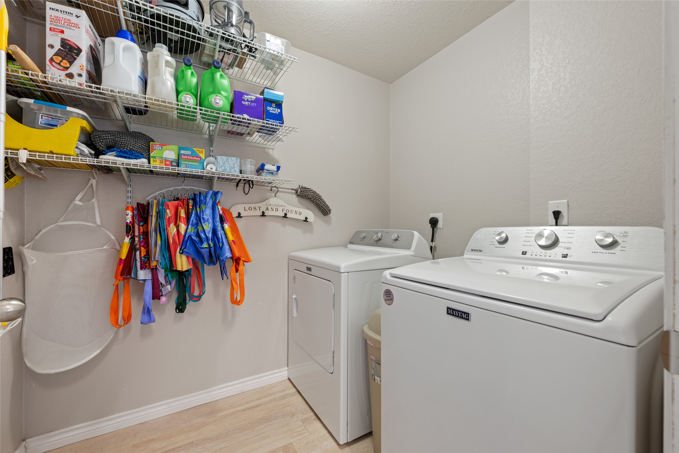 144 Calcite Lane Jarrell, TX 76537 - Photo 28 of 38 A well-appointed laundry room features modern appliances and convenient shelving for organization.
