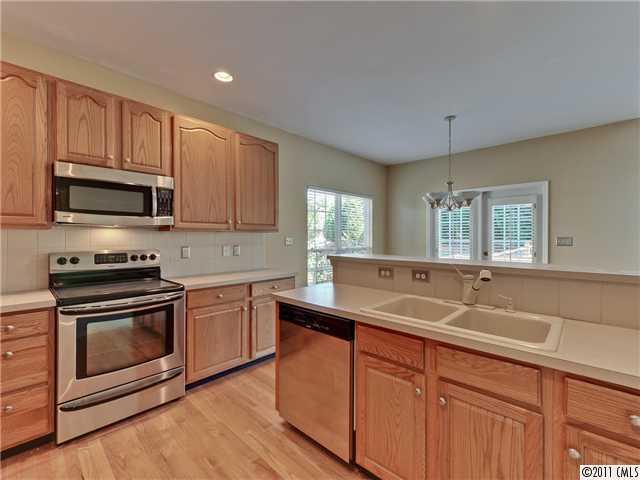 6531 Elfreda Road Charlotte, NC 28270 - Photo 8 of 16 a kitchen with granite countertop a sink cabinets stainless steel appliances and a window