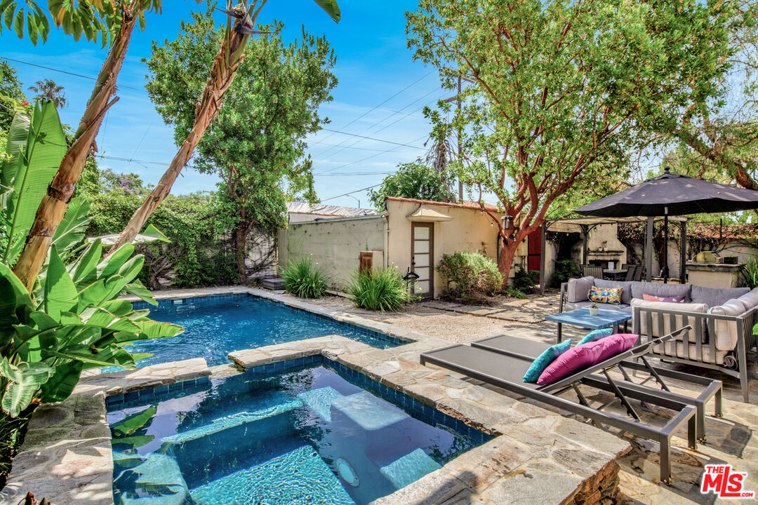 a view of backyard with seating area and trees