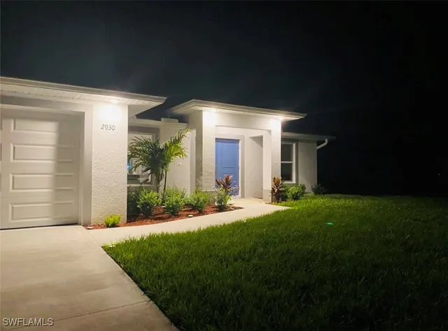 a front view of house with yard and green space