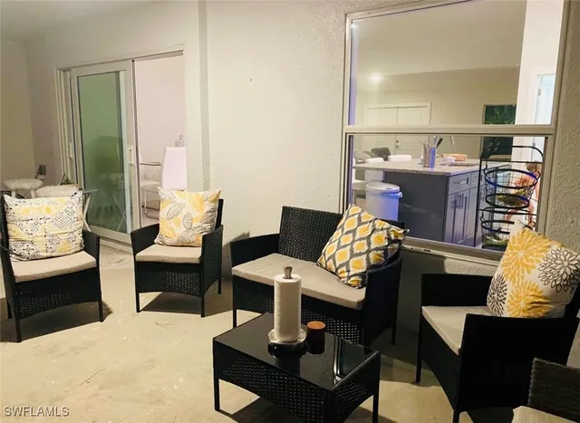 a living room with furniture a rug and a table