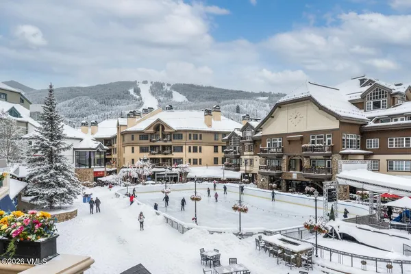 a living room with furniture a large window and a flat screen tv