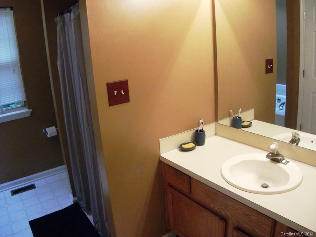 6007 Running Deer Road Charlotte, NC 28214 - Photo 11 of 23 a bathroom with a sink and a mirror