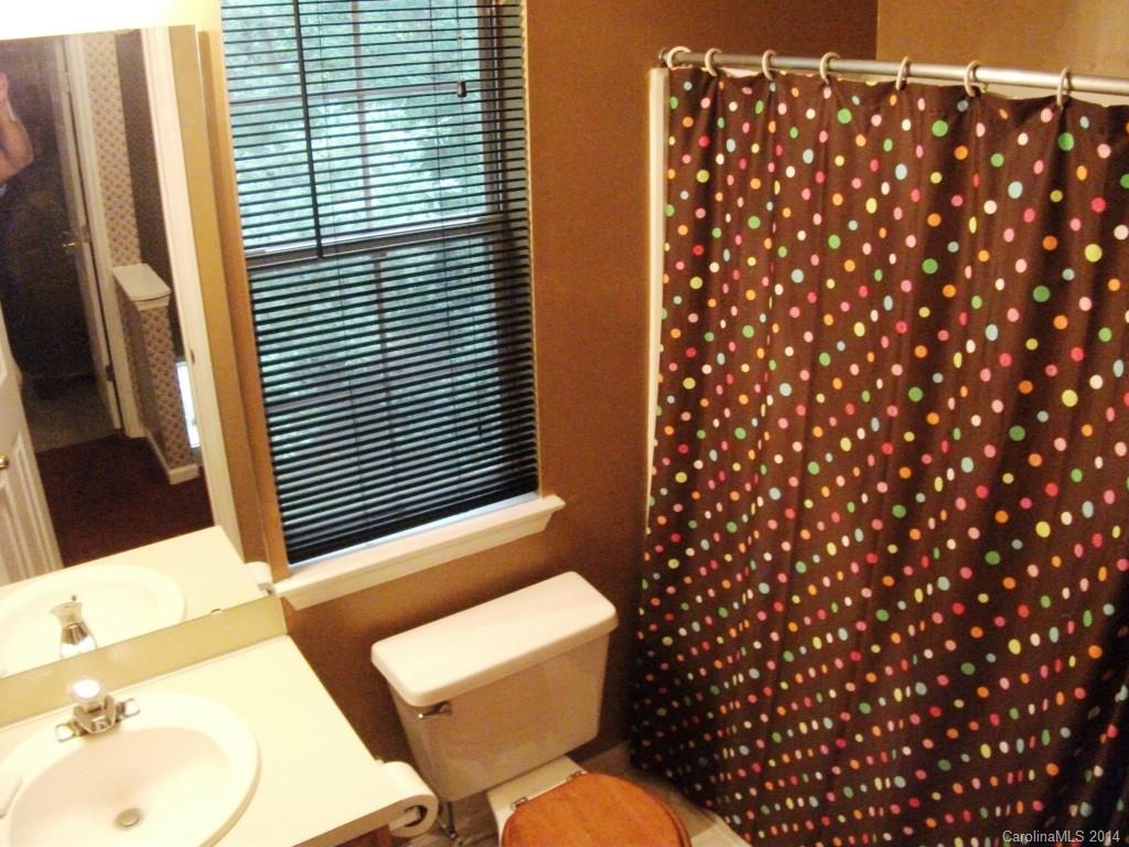 6007 Running Deer Road Charlotte, NC 28214 - Photo 14 of 23 a bathroom with a toilet and a shower curtain
