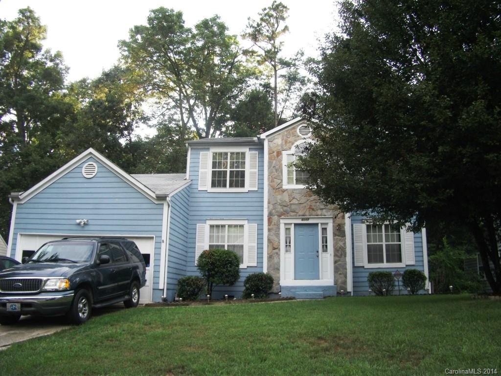 6007 Running Deer Road Charlotte, NC 28214 - Photo 21 of 23 a front view of a house with a garden and trees