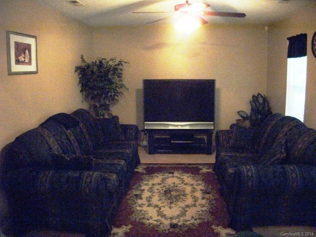 6007 Running Deer Road Charlotte, NC 28214 - Photo 5 of 23 a living room with couches rug and a potted plant