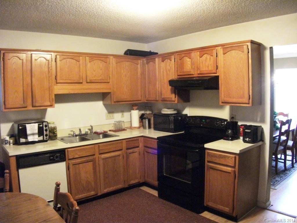 6007 Running Deer Road Charlotte, NC 28214 - Photo 6 of 23 a kitchen with a sink a stove and cabinets
