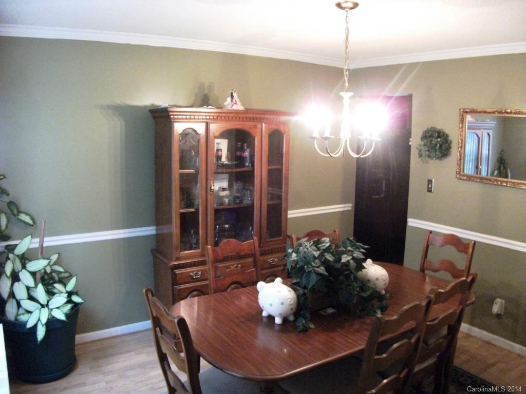 6007 Running Deer Road Charlotte, NC 28214 - Photo 9 of 23 a dining room with furniture and chandelier
