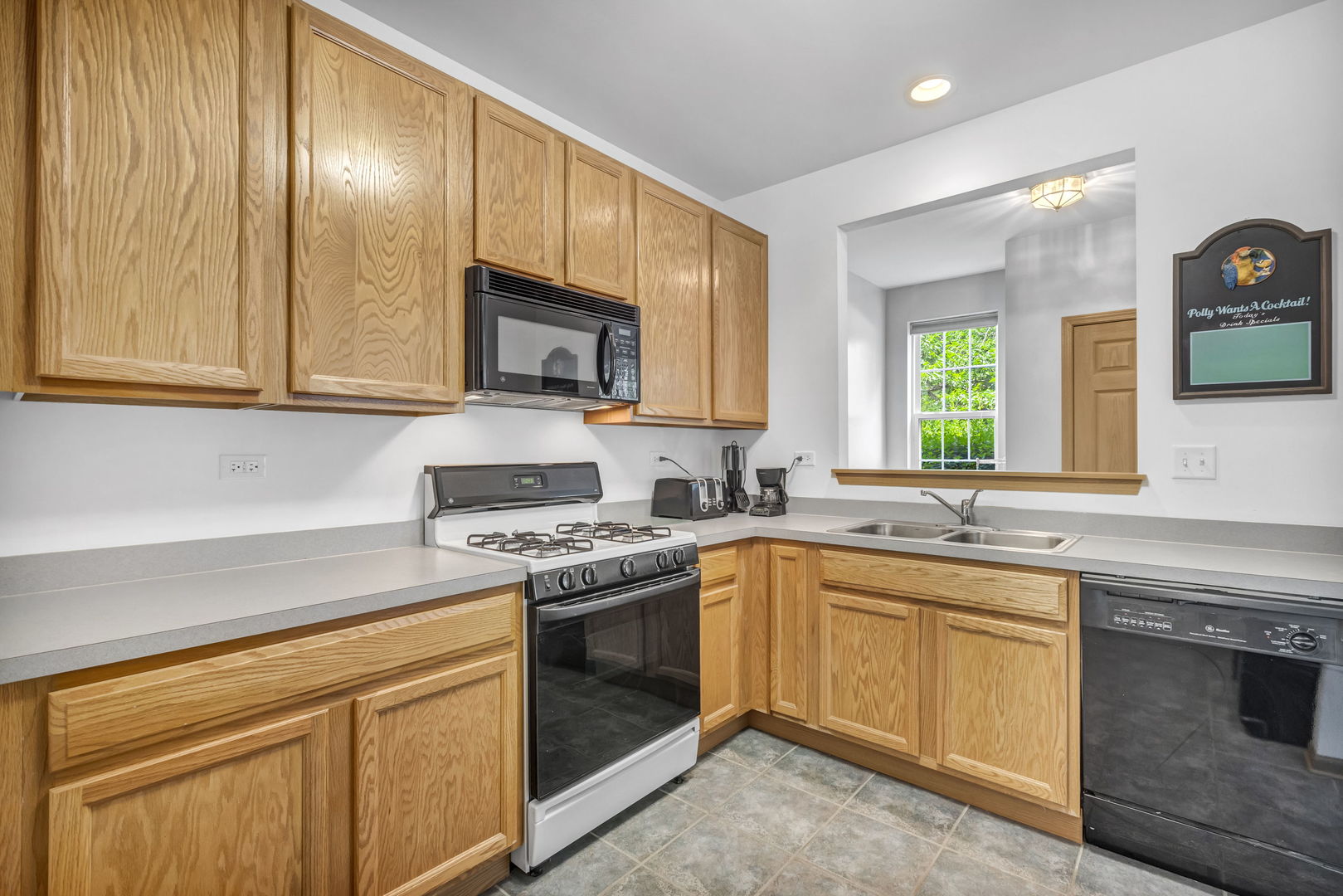 2406 Golf Ridge Circle Naperville, IL 60563 - Photo 8 of 22 a kitchen with stainless steel appliances granite countertop a sink stove and cabinets