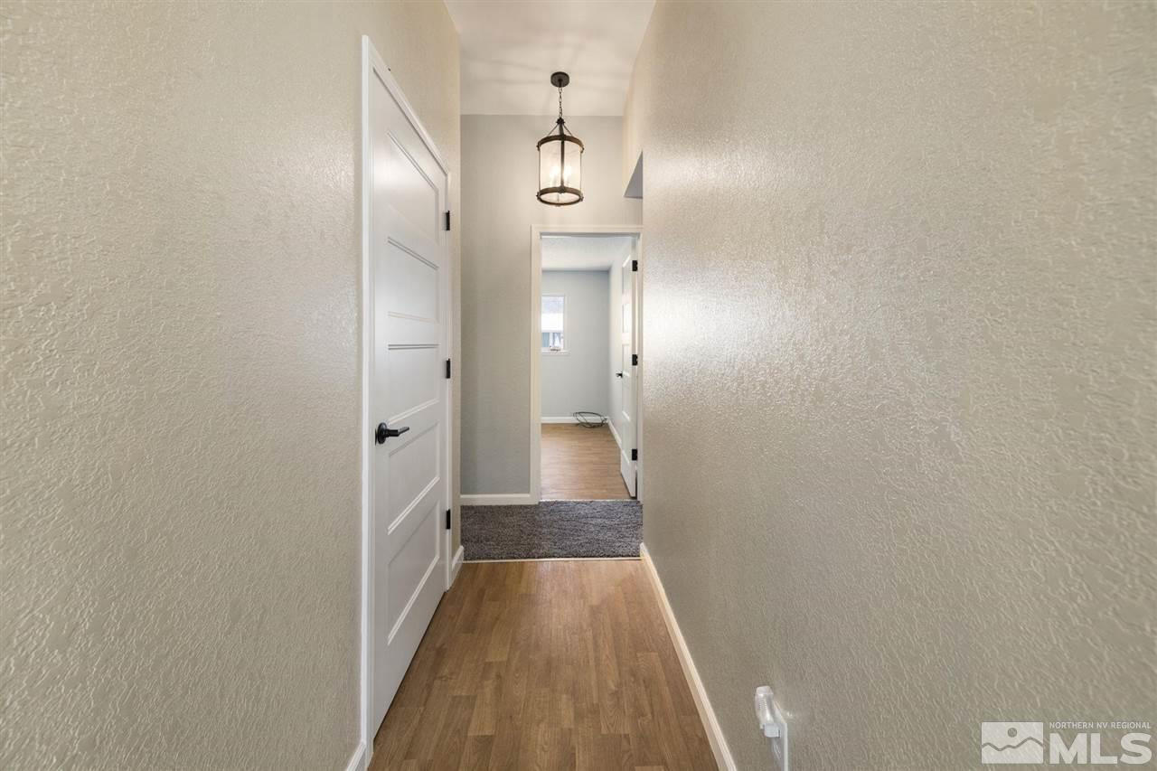 213 Ring Road Dayton, NV 89403 - Photo 17 of 40 a view of a hallway with wooden floor