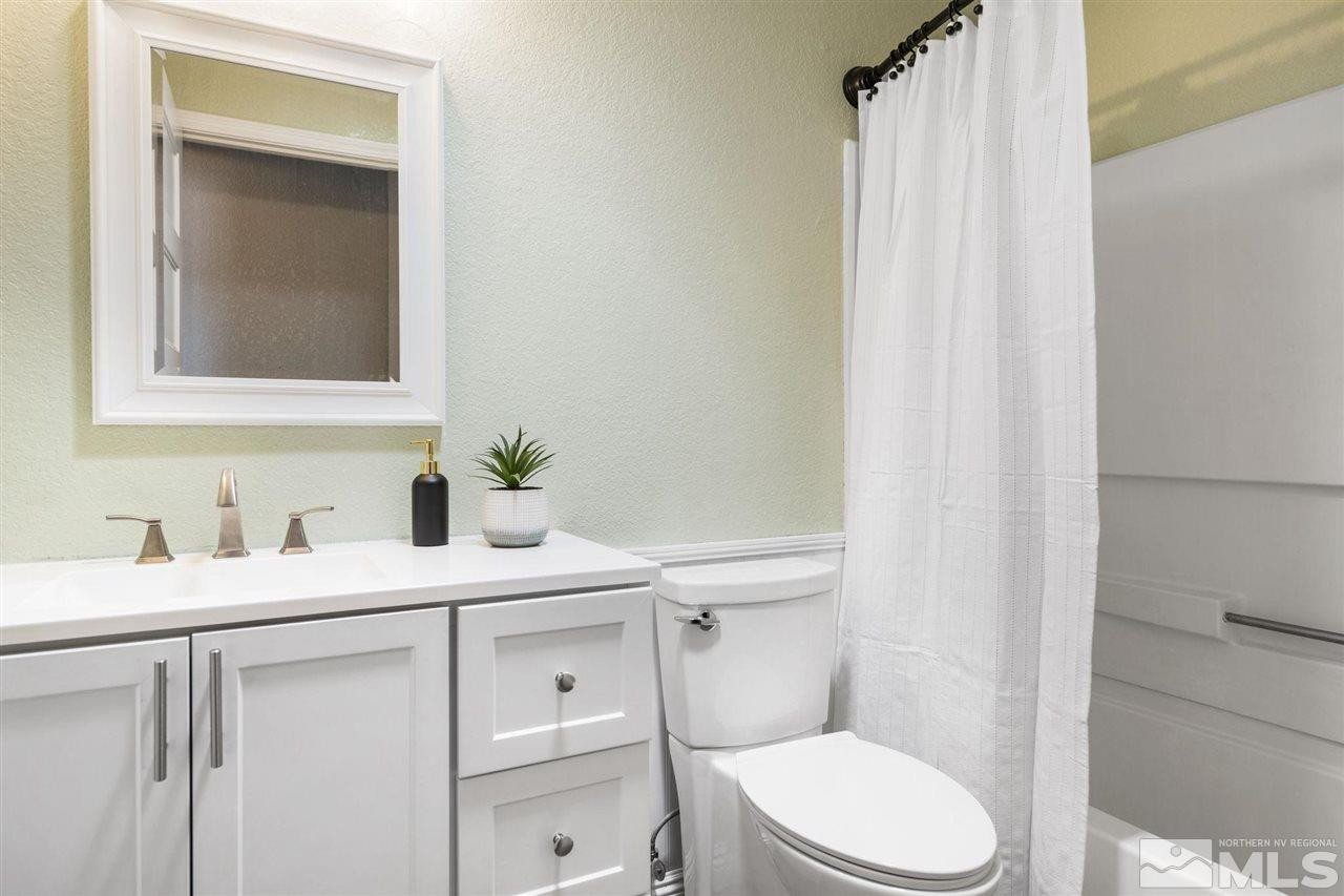213 Ring Road Dayton, NV 89403 - Photo 23 of 40 a bathroom with a granite countertop sink toilet and mirror