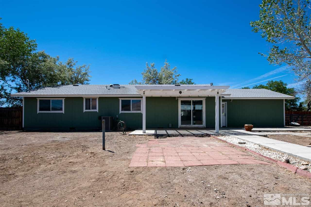 213 Ring Road Dayton, NV 89403 - Photo 28 of 40 a front view of a house with a yard and garage