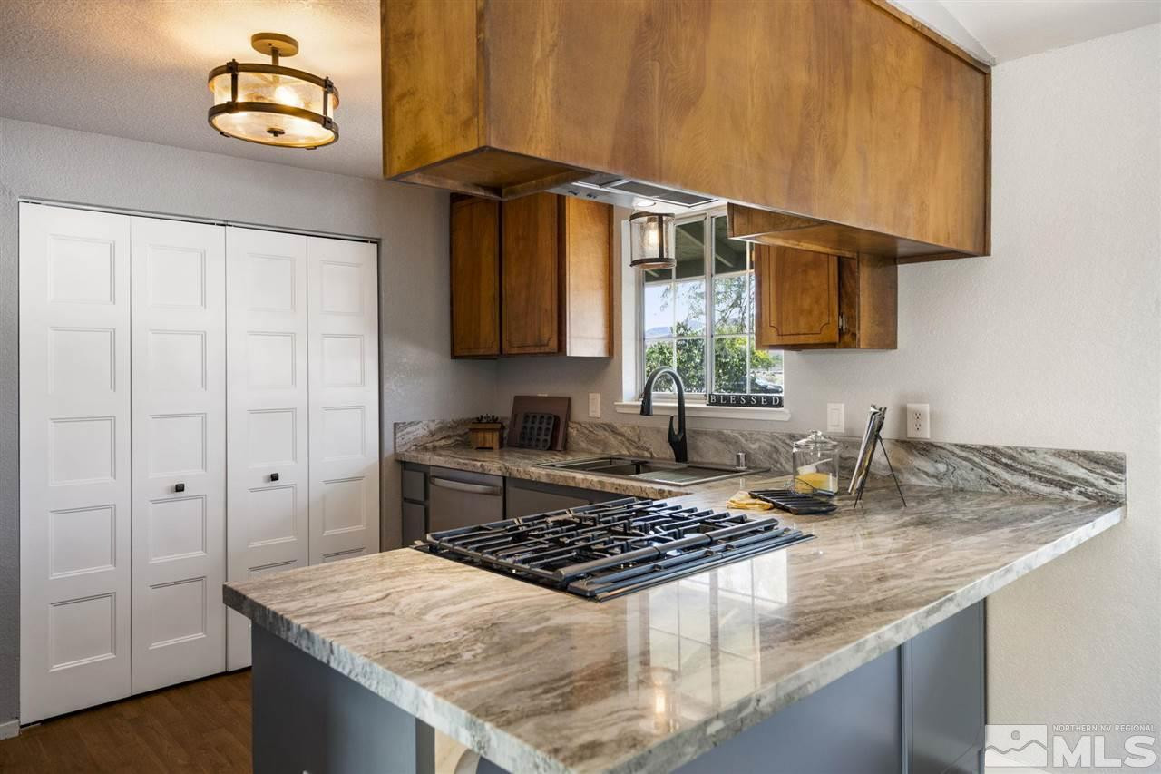 213 Ring Road Dayton, NV 89403 - Photo 3 of 40 a kitchen with a stove and a granite counter top