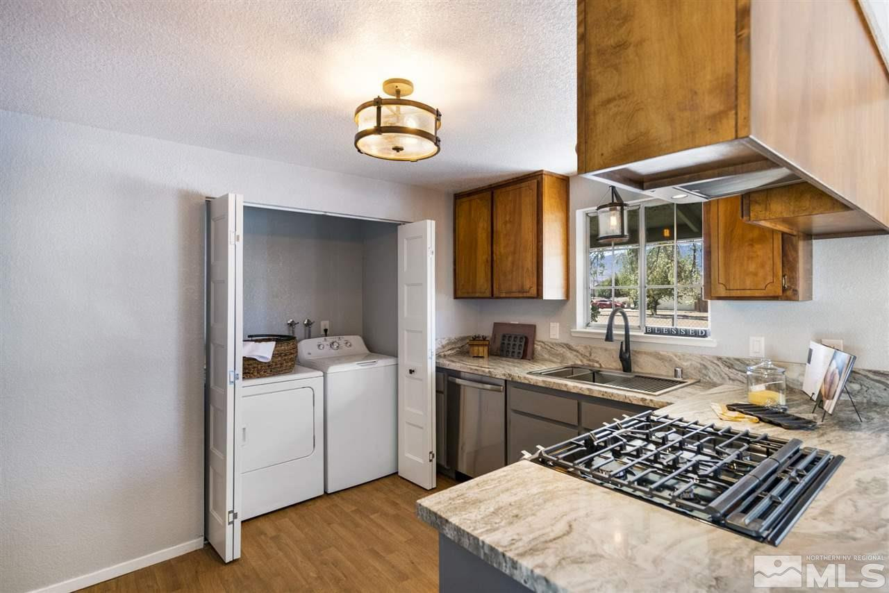 213 Ring Road Dayton, NV 89403 - Photo 4 of 40 a kitchen with a sink and a stove top oven