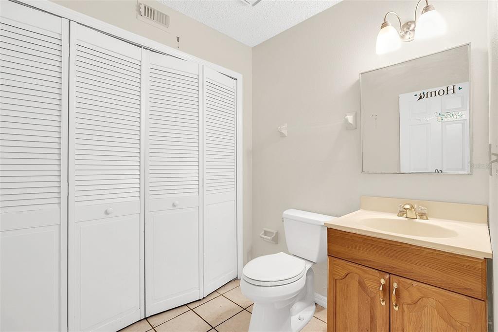 1612 Sandy Point Square, Unit 56 Orlando, FL 32807 - Photo 15 of 26 a bathroom with a sink a toilet and large mirror