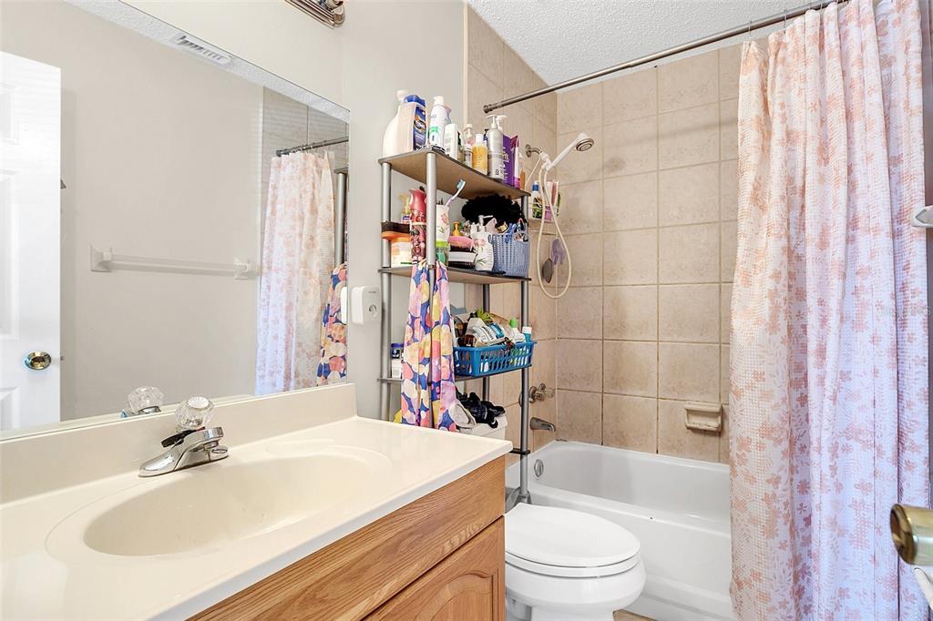 1612 Sandy Point Square, Unit 56 Orlando, FL 32807 - Photo 17 of 26 a bathroom with a sink toilet and shower