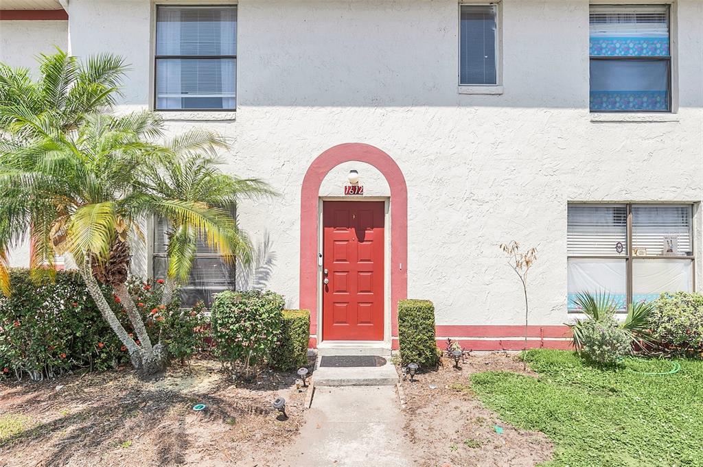 1612 Sandy Point Square, Unit 56 Orlando, FL 32807 - Photo 2 of 26 a front view of a house with garden