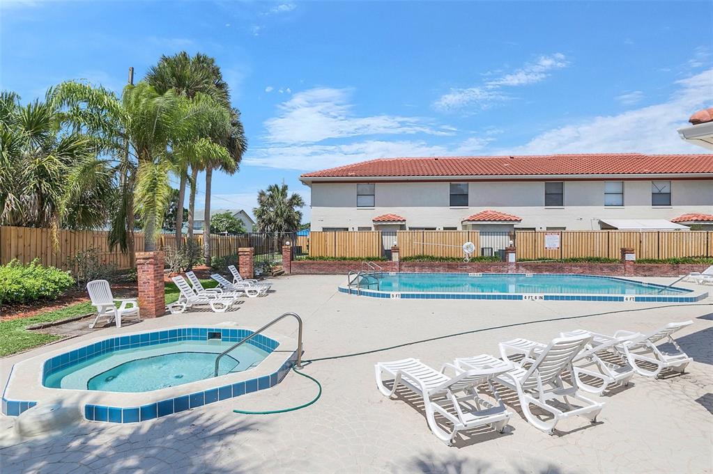 1612 Sandy Point Square, Unit 56 Orlando, FL 32807 - Photo 26 of 26 a view of a swimming pool with a lounge chairs