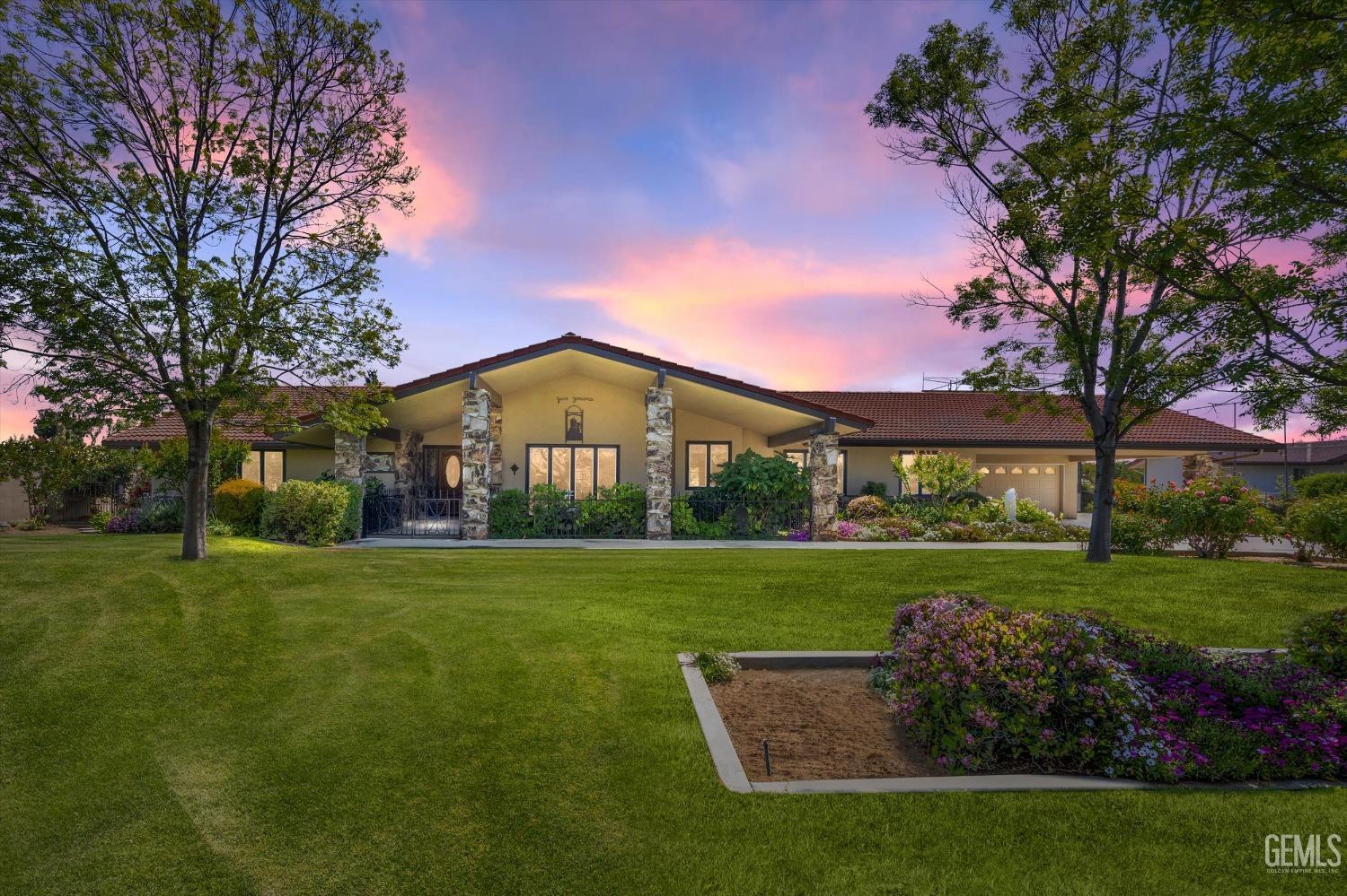 Undisclosed Address Bakersfield, CA 93313 - Photo 1 of 45 a front view of a house with garden