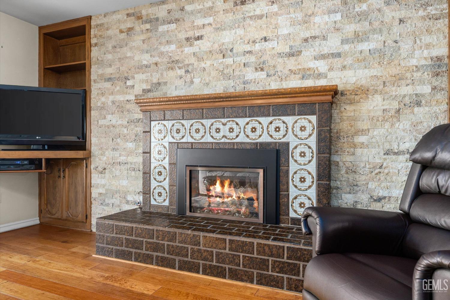 Undisclosed Address Bakersfield, CA 93313 - Photo 15 of 45 a living room with furniture a flat screen tv and a fireplace