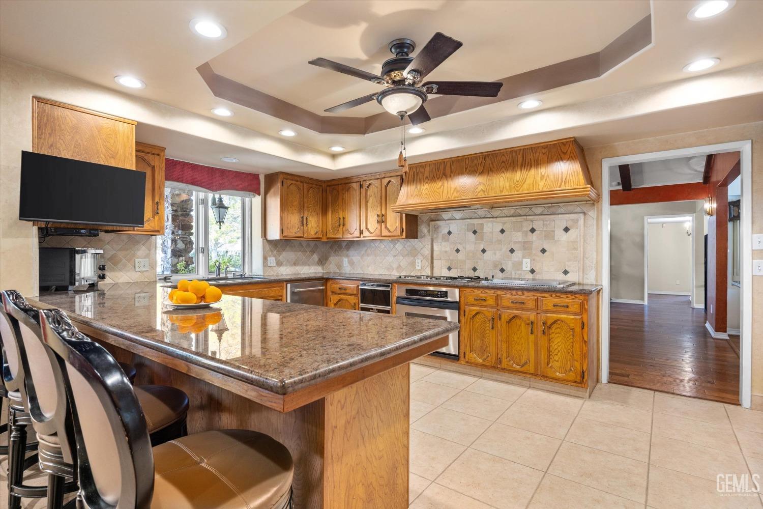 Undisclosed Address Bakersfield, CA 93313 - Photo 17 of 45 a kitchen with stainless steel appliances granite countertop a sink stove and refrigerator