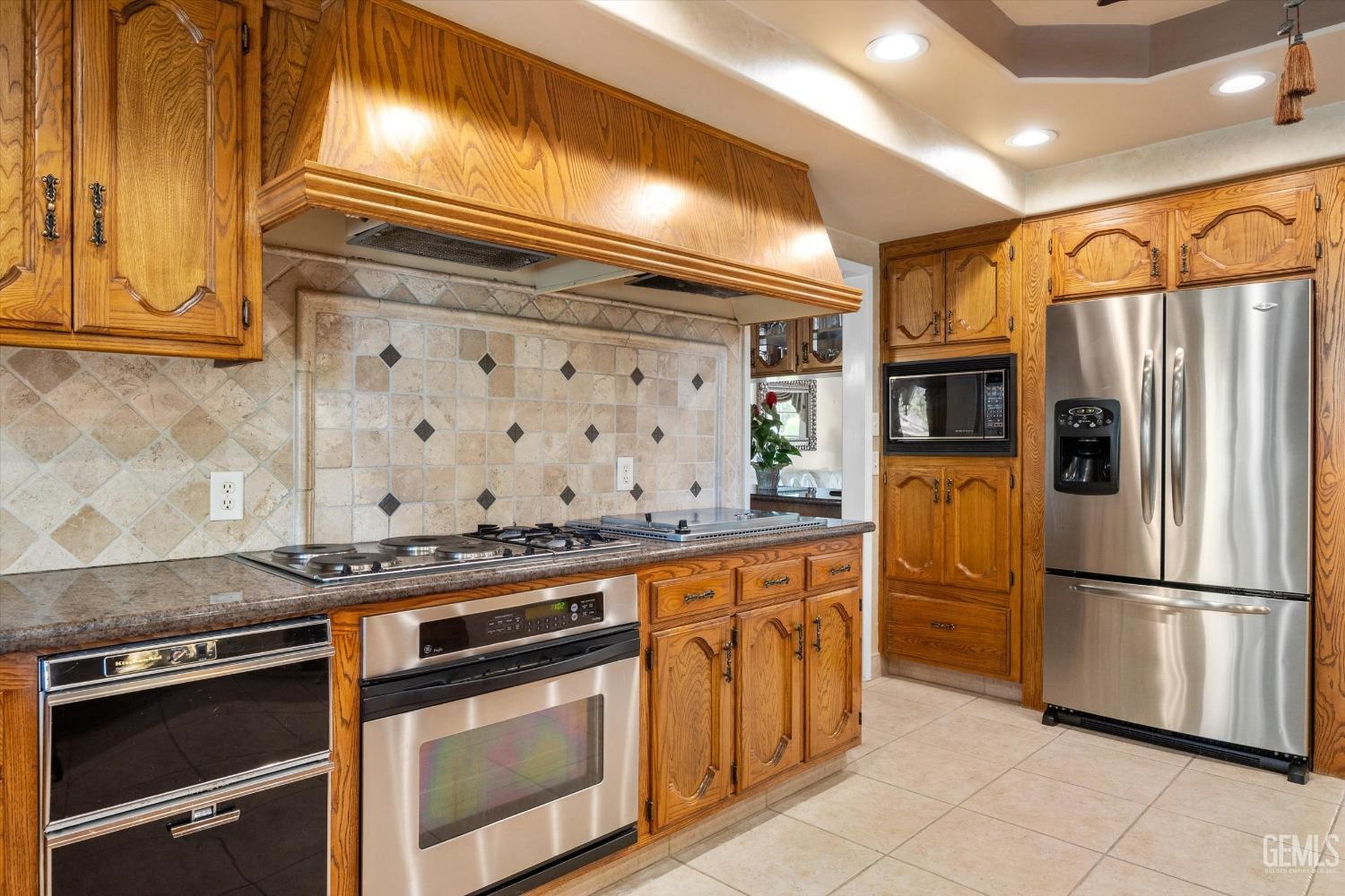 Undisclosed Address Bakersfield, CA 93313 - Photo 20 of 45 a kitchen with stainless steel appliances granite countertop a stove a refrigerator and a microwave