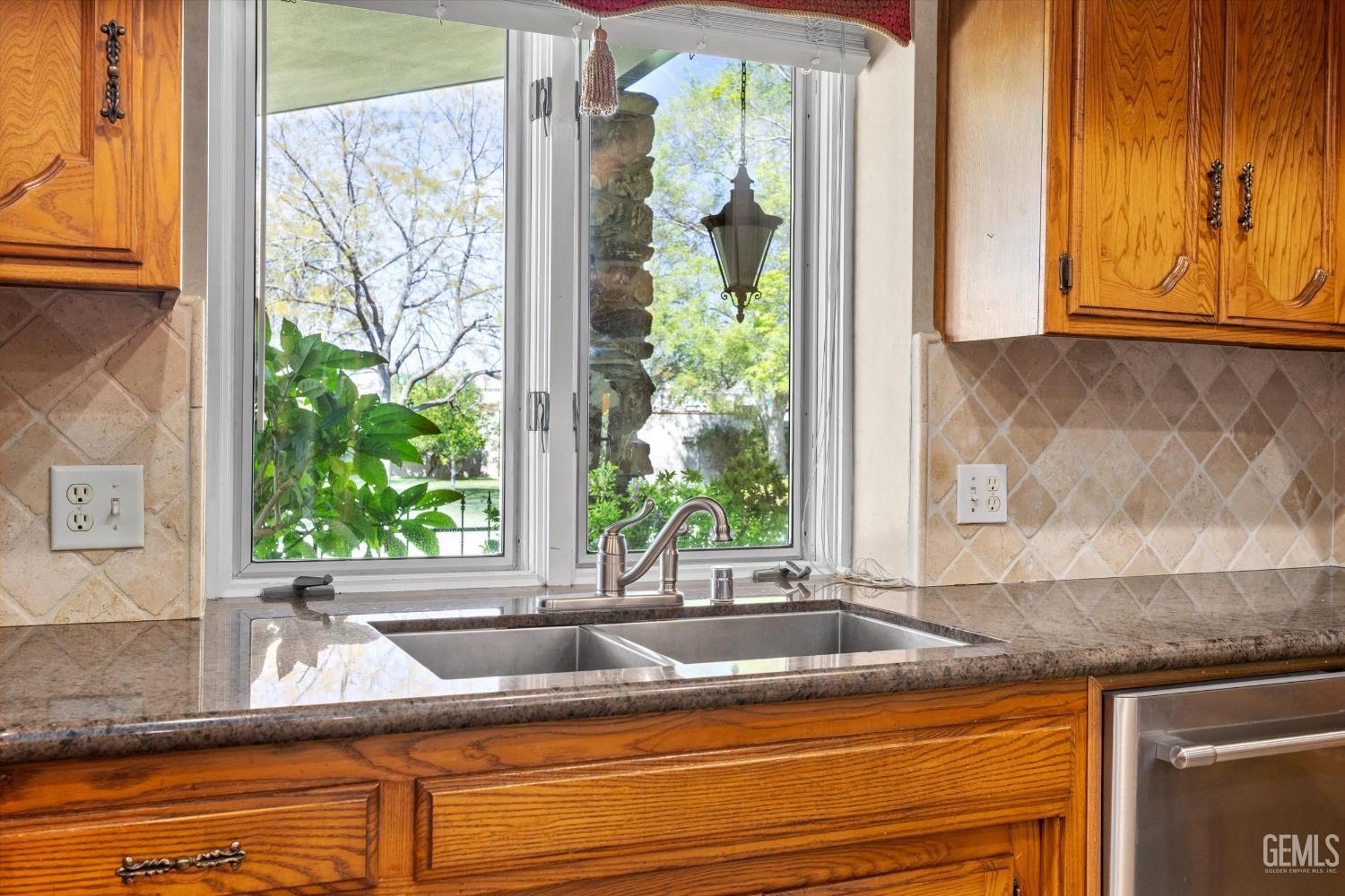 Undisclosed Address Bakersfield, CA 93313 - Photo 21 of 45 a view of a granite countertop sink and a granite counter top