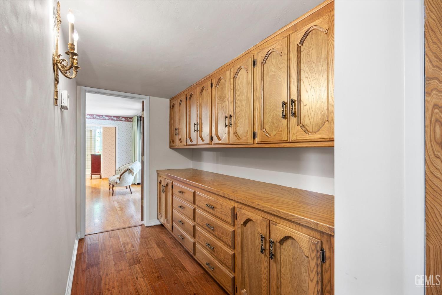 Undisclosed Address Bakersfield, CA 93313 - Photo 22 of 45 a view of a hallway with wooden floor and cabinets