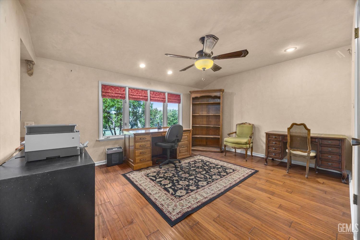 Undisclosed Address Bakersfield, CA 93313 - Photo 25 of 45 a living room with furniture and a wooden floor