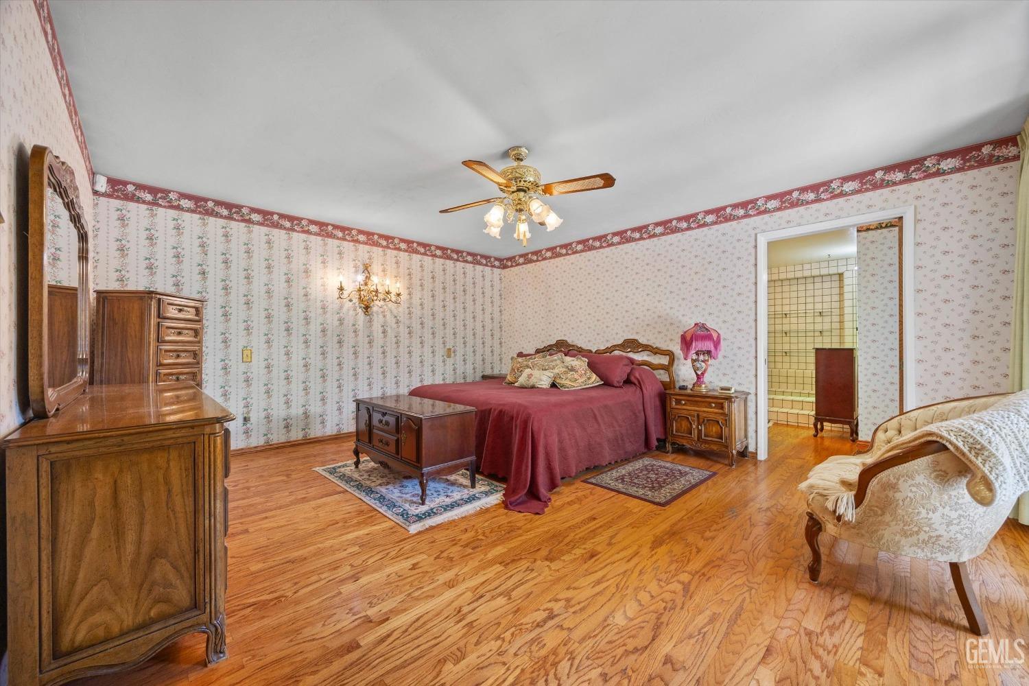 Undisclosed Address Bakersfield, CA 93313 - Photo 27 of 45 a bedroom with a bed and a chandelier