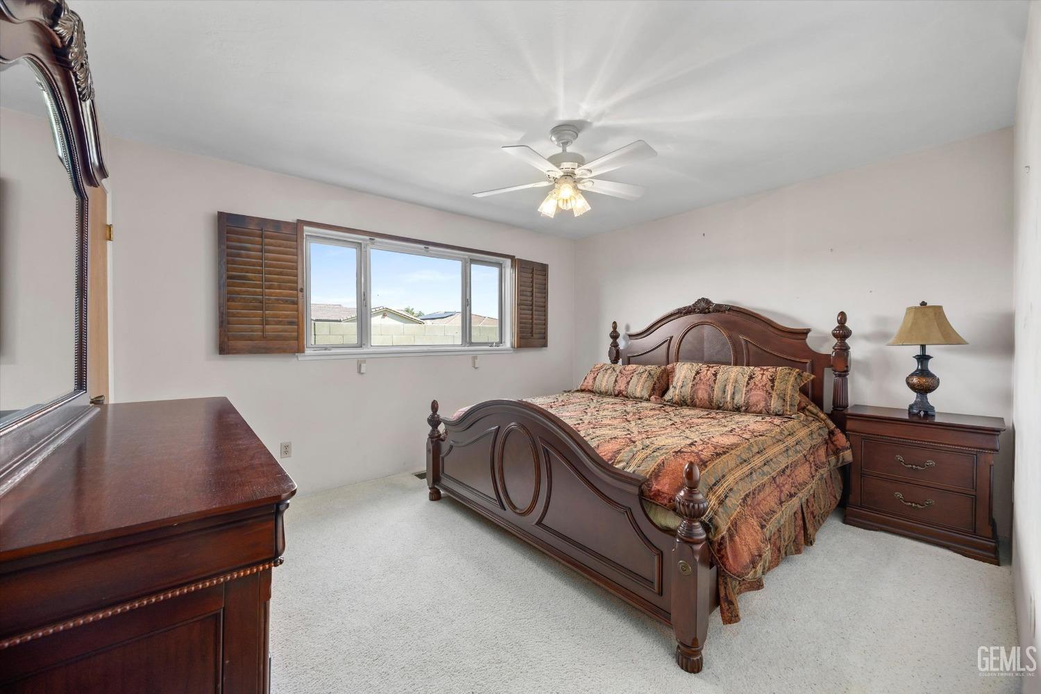 Undisclosed Address Bakersfield, CA 93313 - Photo 32 of 45 a bedroom with a bed chandelier and a window
