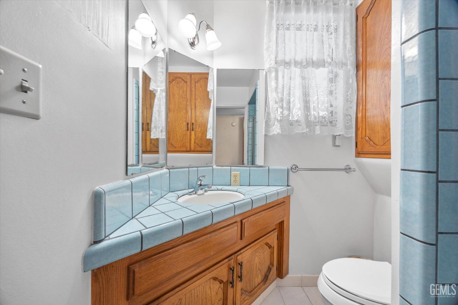 Undisclosed Address Bakersfield, CA 93313 - Photo 35 of 45 a bathroom with a sink a toilet and mirror