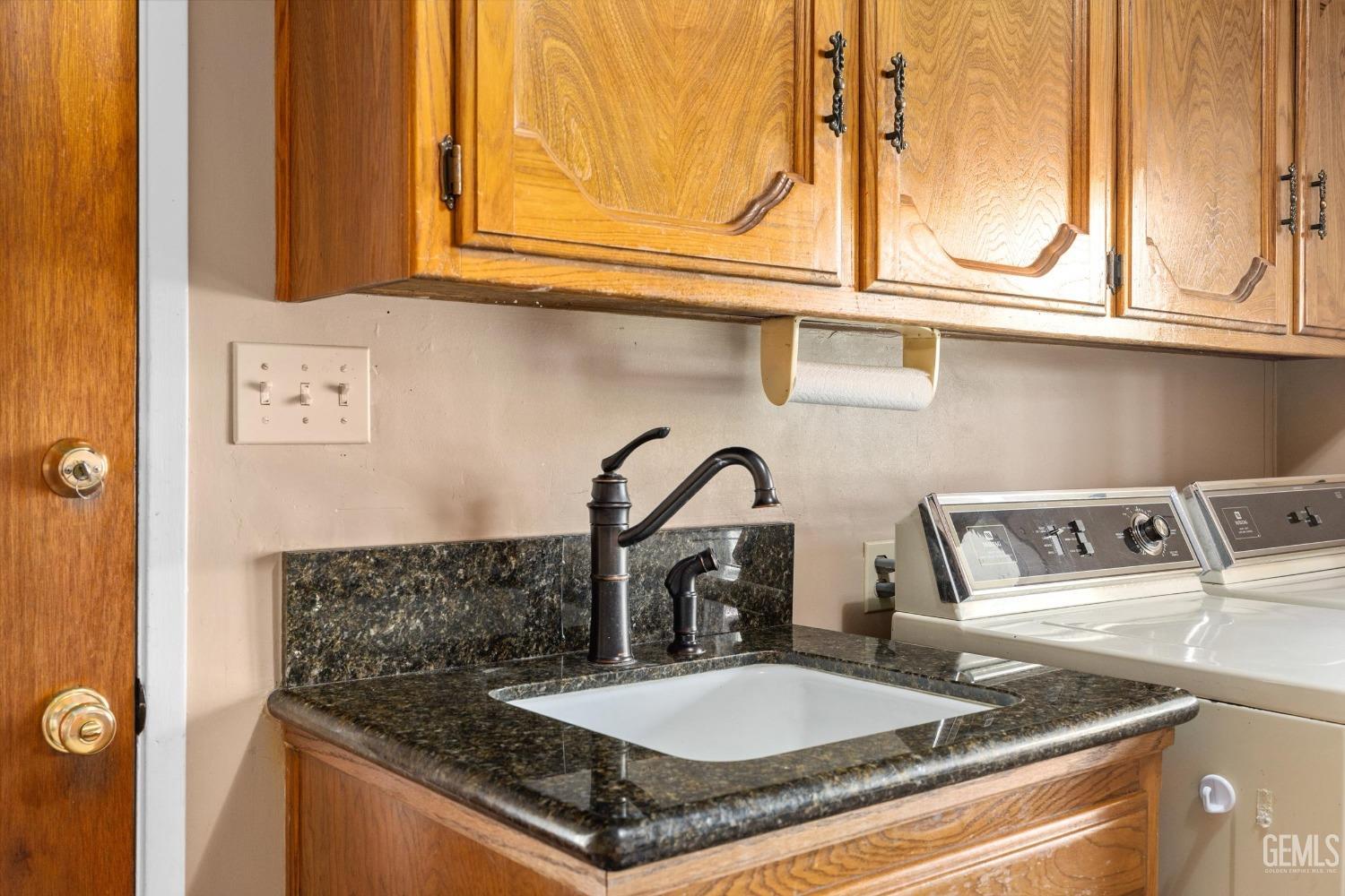 Undisclosed Address Bakersfield, CA 93313 - Photo 37 of 45 a kitchen with a sink and a stove next to a window