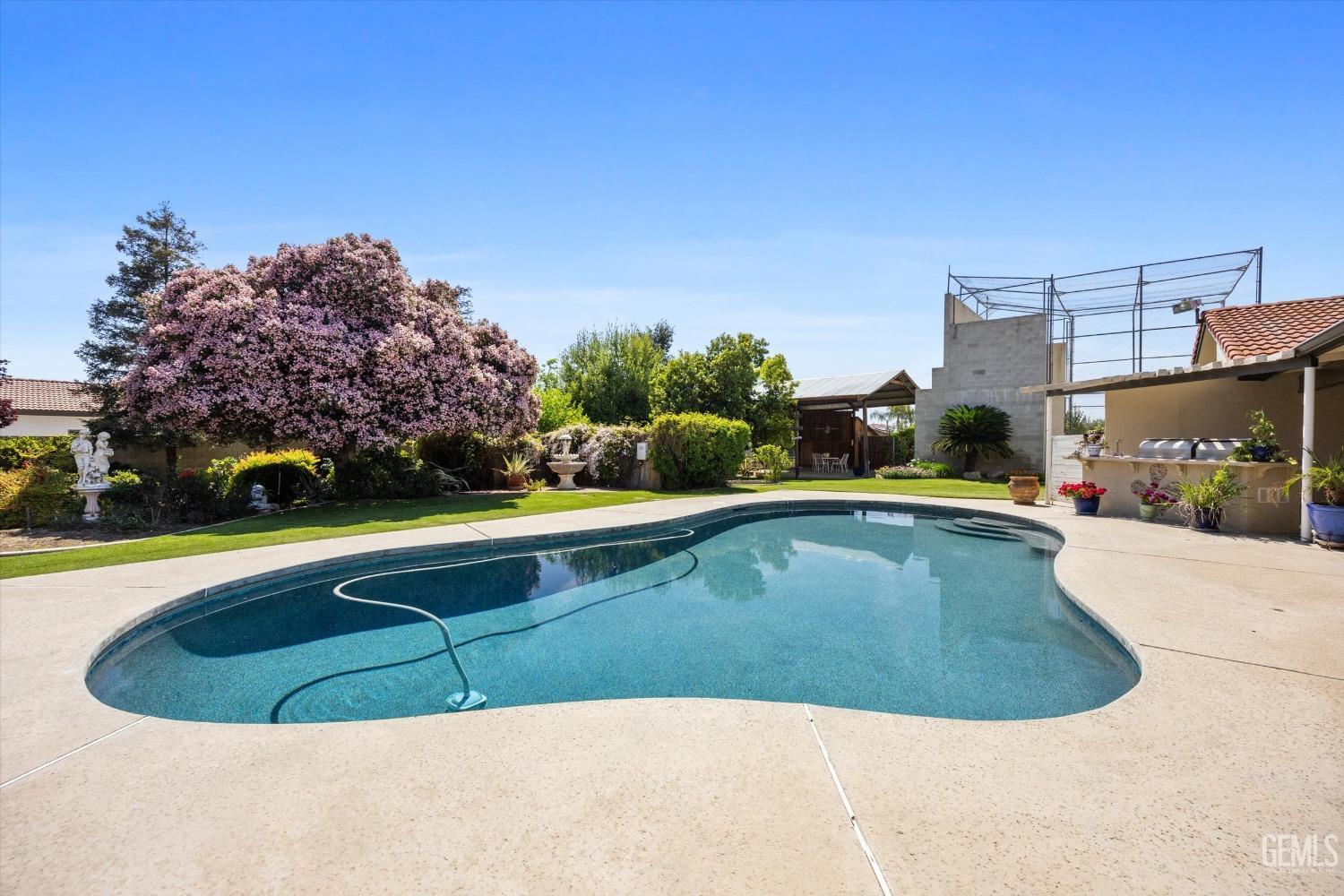 Undisclosed Address Bakersfield, CA 93313 - Photo 40 of 45 a view of a swimming pool with a yard