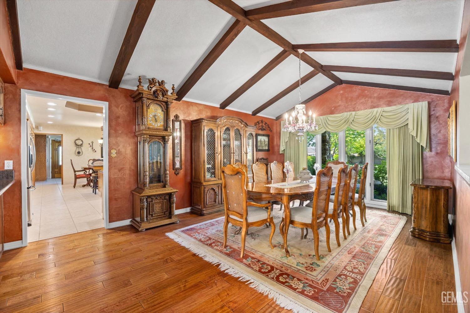Undisclosed Address Bakersfield, CA 93313 - Photo 7 of 45 a dining room with furniture a chandelier and wooden floor