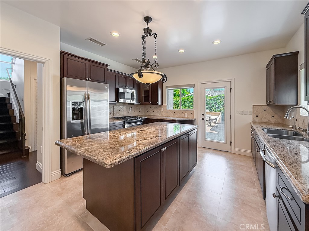5960 Balcom Avenue Encino, CA 91316 - Photo 13 of 58 a kitchen with stainless steel appliances granite countertop a sink stove and refrigerator