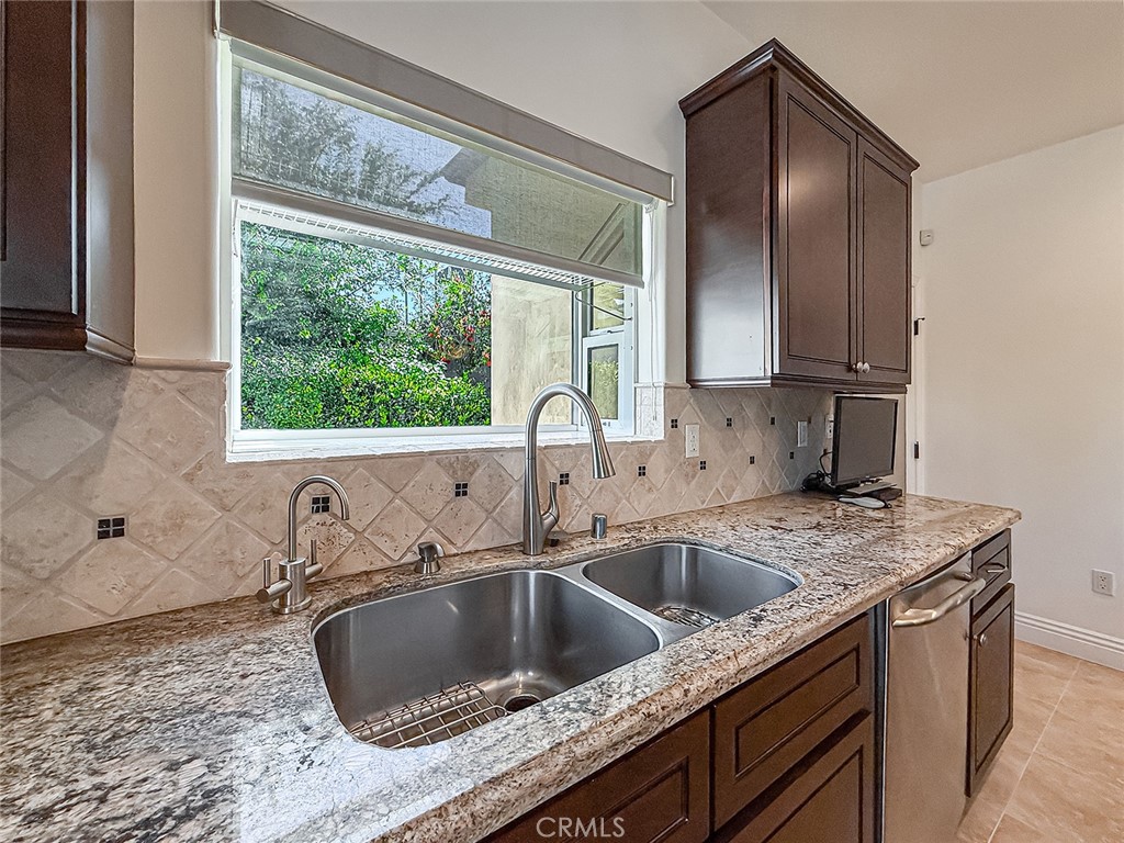 5960 Balcom Avenue Encino, CA 91316 - Photo 15 of 58 a kitchen with granite countertop a sink and a window