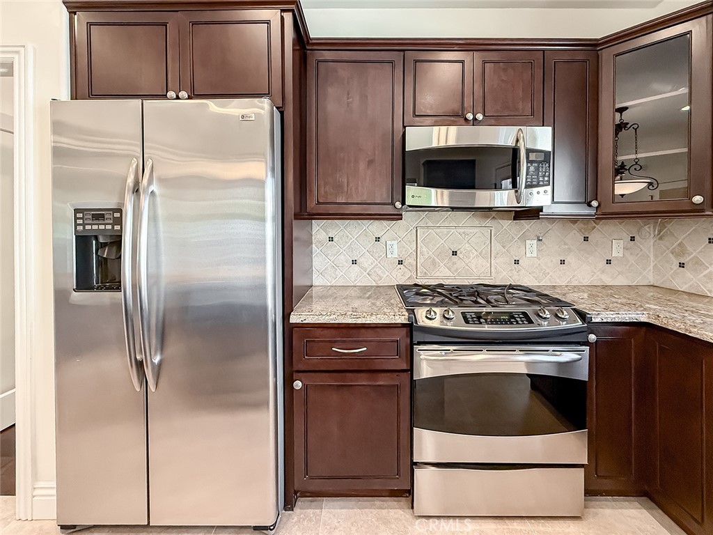 5960 Balcom Avenue Encino, CA 91316 - Photo 16 of 58 a kitchen with stainless steel appliances granite countertop a stove a refrigerator and a microwave